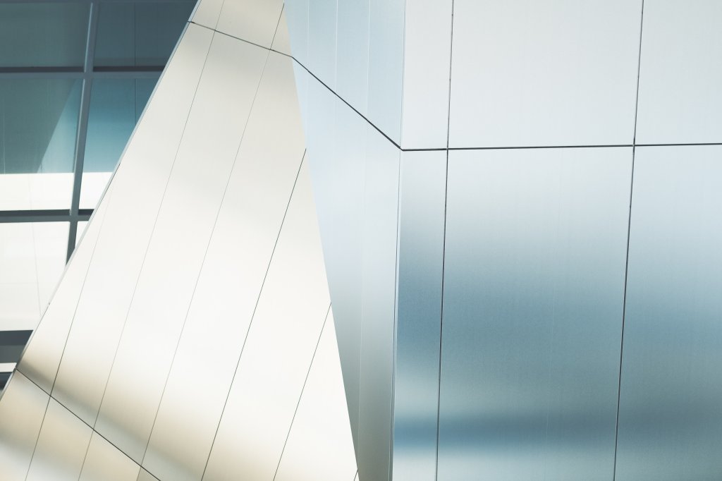 Akron Art Museum, Akron, in the United States. A close-up of a steel-like curtain building structure. It's bent at a 45-degree angle, and the building's material is a luxurious shiny steel.